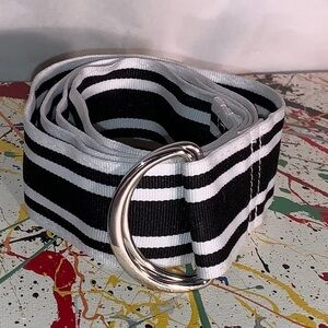 D-ring, black and white striped canvas belt.